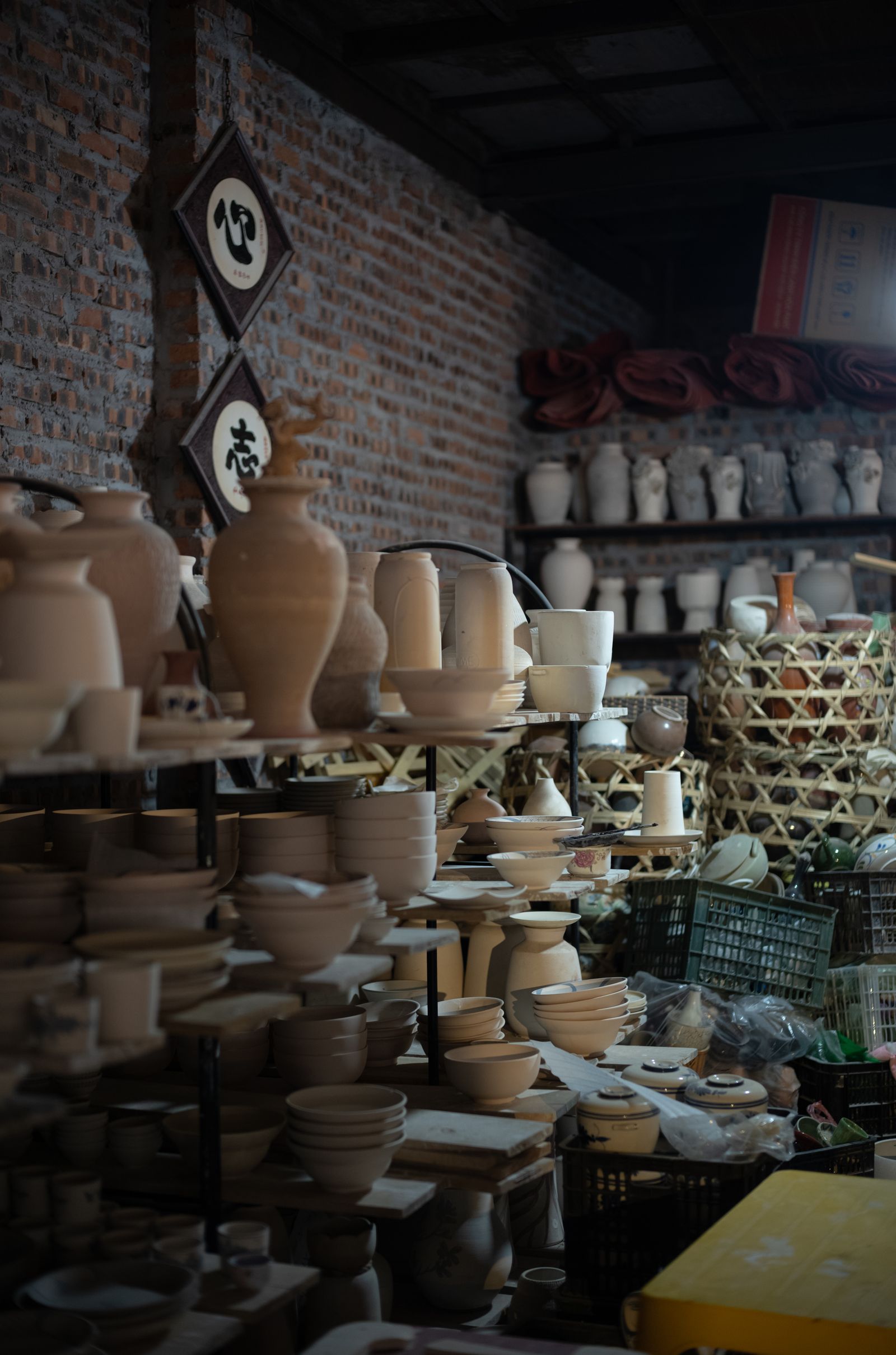 Shelves filled with pottery in a working studio